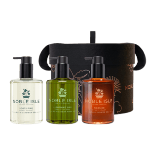 The Noble Retreat Gift Set including three 250ml bath & shower gels in Scots Pine, Fireside and Lightning Oak fragrances with a black hat pack behind.