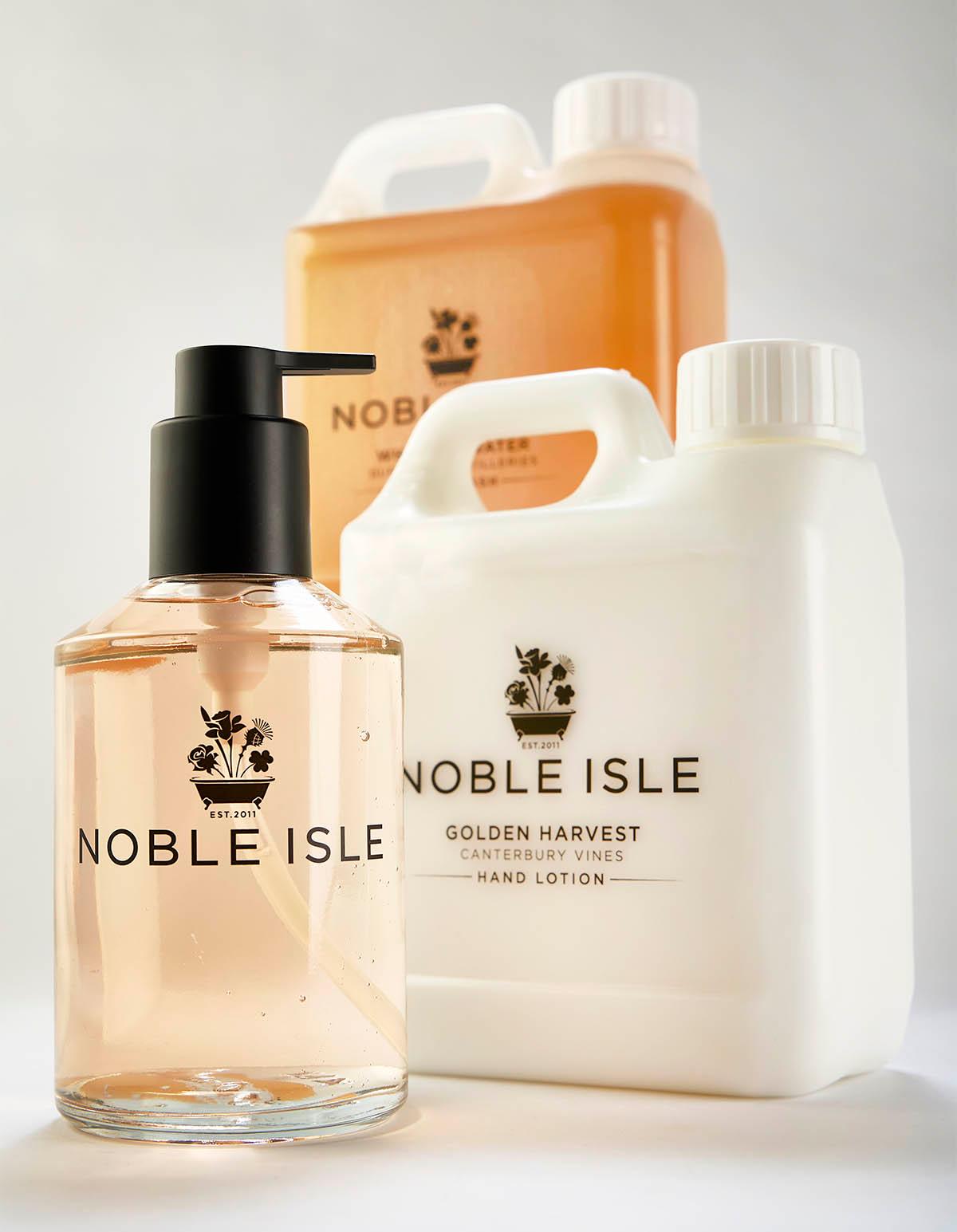 Noble Isle 1-Litre and 300ml Glass refill bottles on a grey background